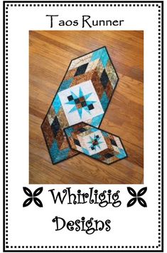 a quilted table runner with the words whirligg designs written below it