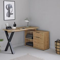 a wooden desk with two drawers and a lamp next to it in a white room