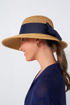 Toucan Hats makes our best-selling and beloved beach accessories.This bow-trimmed hat offers pretty protection from the sun with a nautical navy ribbon detail. Wear to the beach with your favorite caftan for a classic, feminine, and practical finishing touch. The best part? It's packable so it will easily fit in your suitcase or weekender, and keeps its shape after you pull it out. Wide brim Navy bow detail Packable Material: Woven Straw Navy Hat For Spring, Adjustable Beach Hat With Bow, Chic Sun Hat With Bow For Vacation, Chic Vacation Sun Hat With Bow, Beach Straw Boater Hat With Bow, Vacation Brimmed Straw Hat With Bow, Straw Boater Hat With Bow For Vacation, Beach Boater Hat With Bow, Blue Boater Hat With Curved Brim For Beach