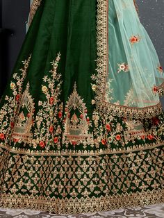 Look gorgeous in this bottle green taffeta satin silk bridal lehenga for woman decked with intricate Thread, Dori, Zari Embroidery with stone work.
Also comes with a matching color taffeta satin silk embroidered choli and mint green net embellished dupatta with similar work lace details. Green Embroidered Sharara In Dola Silk, Green Anarkali Lehenga With Resham Embroidery, Embroidered Green Sharara In Dola Silk, Green Lehenga With Intricate Embroidery For Festive Occasions, Floor-length Green Lehenga With Resham Embroidery, Unstitched Green Embroidered Lehenga, Embroidered Green Lehenga For Reception, Bollywood Green Lehenga With Intricate Embroidery, Anarkali Style Green Lehenga With Resham Embroidery