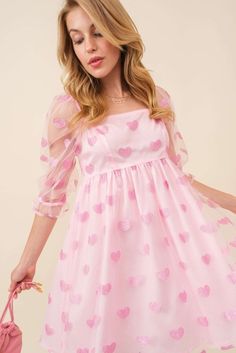 This charming pink dress is designed with a fun flair! Adorable glitter heart patches are sprinkled all over for a touch of magic! Crafted from a lightweight tulle mesh material in a flattering babydoll silhouette and a mini hem length. Featuring a square neckline, elastic sleeved and a zipped per back closure. This darling dress is perfect for any occasion! Glitter heart patches Lightweight Square Neckline Elastic shoulder Tulle 3/4th sleeves Zipper clousure 100 Poly True to size Size Guide: SM Lover Aesthetic Outfits, Coquette Dress, Lover Dress, Sequin Dresses, Heart Patches, Darling Dress, Heart Dress, Glitter Hearts, Mesh Material