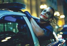 the dark knight joker is getting out of his car and ready to go for action