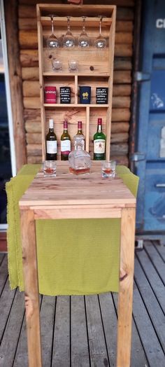 a wooden table with bottles and glasses on it