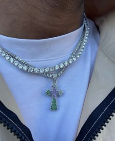 a man wearing a necklace with a cross on it