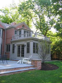 a large brick house with an attached deck