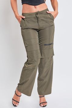 We’re obsessed with our new Women’s High Rise Nylon Cargo Pants, and we think you will be too. This high waisted parachute-inspired pant is constructed with lightweight polyester for a nice airy feel and features a straight-leg, relaxed fit that you'll want to wear all the time. Detailed with two functional cargo pockets at the knee, one faux cargo pocket at the thigh, and one decorative zipper for that added edge. Pair with a baby tank and tennies for a cool-casual look, or with a corset top an Stretch Nylon Wide-leg Parachute Pants, High-waist Nylon Parachute Pants With Elastic Waistband, Trendy High-waist Nylon Pants, Trendy High Waist Nylon Pants, Khaki Straight Parachute Pants For Outdoor, High-waist Utility Parachute Pants For Outdoor, Trendy Nylon Parachute Pants, High Waist Utility Parachute Pants For Outdoor, Utility High Waist Parachute Pants For Outdoor