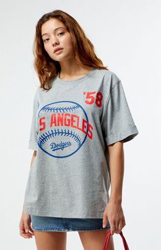 PacSun exclusive! Show off your team spirit with the MLB Wild Collective x PacSun Oversized T-Shirt. This tee features short sleeves, a crew neckline, and a bold baseball team graphic on the front. With its relaxed oversized fit, it’s perfect for a casual day out or cheering from the stands.Solid color teeShort sleevesCrew necklineFront graphicSmall side slitsOversized fit100% cottonMachine washableModel is wearing a size smallModel measurements: 5’6.5” height, 32” bust, 23” waist, 35” hips Wome Sporty Oversized T-shirt For Game Day, Game Day Summer T-shirt With Screen Print, Summer Game Day T-shirt With Screen Print, Summer Fan Apparel T-shirt For Sports Events, Oversized Sporty T-shirt For Game Day, Graphic Tee T-shirt With Team Name For Summer, Summer Team Spirit Crew Neck T-shirt, Collegiate Tops With Graphic Print And Relaxed Fit, Collegiate Graphic Print Relaxed Fit Tops