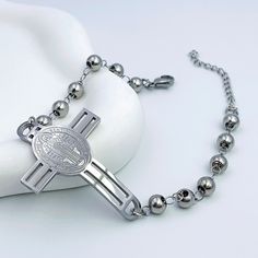 Our large cross bracelet features a prominent cross bead as its centerpiece, elegantly linked with smaller cross beads throughout the chain—a symbol of faith designed to inspire and empower you on your spiritual path. Available in silver and gold. Cross Beads, Small Crosses, Spiritual Path, Cross Bracelet, Silver And Gold, Ring Necklace, The Chain, A Symbol, Ring Earrings