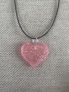 "This super cute, medium-large sized multi colored glass heart pendant is absolutely stunning. The pendant looks fantastic from every angle. It is strung along a 20-22\" length black cord. This can be placed on 18-20\" black cord if requested for no additional charge. This is an absolutely gorgeous pendant and would be a great birthday present, anniversary present, Mother's Day gift, Christmas present, or graduation gift. The sleek design of this pendant will turn heads and make you take a secon Pink Heart Necklace For Gift, Resin Heart Necklace, Y2k Heart-shaped Necklace For Gifts, Grunge Heart-shaped Necklace For Gifts, Pink Adjustable Heart-shaped Necklace, Heart-shaped Resin Necklace For Valentine's Day, Hippie Necklace, Pink Necklace, Valentines Gifts For Her