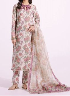 Material: High-quality filament Zari fabric this three-piece outfit, you'll find a modern shirt adorned with intricate embroidery on a powder coral floral print canvas. It's perfectly matched with straight trouser in the same print, and the ensemble is elegantly completed with a traditionally draped printed dupatta, featuring an embroidered border for added charm. Color. beige  Occasion: Ideal for weddings, parties, or cultural events Ready to wear, no hassle of stitching Comfortable and easy to move in Exquisite craftsmanship Care Instructions: Dry clean only for long-lasting beauty and durability.  the color of the product in the photo might look slightly different in person due to factors like lighting and screen settings." Designer Unstitched Chanderi Suit With Floral Embroidery, Eid Floral Print Georgette Salwar Kameez, Floral Georgette Salwar Kameez For Eid, Embroidered Unstitched Organza Suit With Long Sleeves, Spring Designer Georgette Lawn Suit, Eid Floral Georgette Salwar Kameez, Festive Floral Embroidered Chanderi Unstitched Suit, Long Sleeve Embroidered Organza Sharara, Embroidered Long Sleeve Organza Sharara