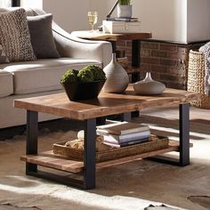 a living room with a couch, coffee table and vases on the side tables