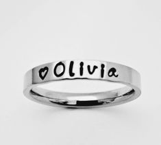 Petite name ring. Stacking name ring. Personalized name ring. This GOREOUS 3 mm ring is super shiny. Great for stacking. The surface is flat, so the lettering really stands out! Add names, initials, dates, quotes, roman numerals or scripture. I have the heart, double heart, infinity, #, &, @, !, =, *, :, ?, cross, baby foot, angel, and ribbon stamps. 15-character limit. Made of solid surgical Stainless steel which will never rust, tarnish, change color and is hypoallergenic. Swim & shower safe! Dates Quotes, Infinity Cross, Ring Name, Name Ring, Name Rings, Personalized Ring, Ring Stacking, Double Heart, Personalized Rings