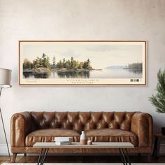 a living room with a leather couch and coffee table in front of a painting on the wall