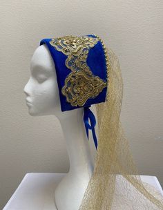 New adult women's Renaissance Medieval Tudor Elizabethan queen royalty blue velvet beaded look hat cap costume. Ornate gold beaded design look headband with flowing gold sheer back veil. Gold beads to adorn the crown. Ribbon back tie to hold in place. 16 1/2" by 5" crown and 23" length veil. Sales final. Great for your next theme party, stage production or special event. Tudor Bonnet Hat, Gold Mardi Gras Costume Hats And Headpieces, Gold Crown Costume Hat, Gold Costume Hats With Round Crown, Gold Tall Crown Costume Hats And Headpieces, Fitted Gold Costume Hat For Carnival, Adjustable Gold Costume Headpieces, Gold Adjustable Costume Hats And Headpieces, Adjustable Gold Costume Hat For Costume Party