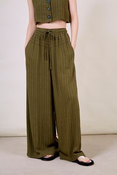 - Model: 177 cm / 5'10'' wearing S/M.- Fit: True to size- Materials: 70% rayon, 30% linen- Thickness: Moderate- Sheerness: None- Stretch: None- Lining: None- Care: Dry clean or hand wash cold and dry flat in shade Striped Linen Pants With Elastic Waistband, Drawstring Trousers, London Free, Fresh Design, Spring 2023, Green Fashion, Buy Now Pay Later, Parachute Pants, Fashion Brand