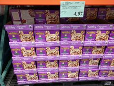 many boxes of cinnamon rolls are on display in a grocery store for $ 4 99