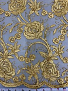 Dakota GOLD Polyester Corded Floral Embroidery on Mesh Lace Fabric by the Yard - 10043 Content: 100% polyester Stretch: Minimal to none Width: 50 to 52 inches Edge: Scalloped on both edges Uses: Wedding dress, evening gown, formal wear, dress, tops, skirts, costumes, decorations, crafts, etc. DISCLAIMER: Expedited shipping options do not apply to 5, 10, 50 and 100 yard options. Sample/Swatch: 4x2 inches for $4.99 each, free shipping. We highly suggest buying a sample first to see and feel the fa Traditional Embroidered Gold Fabric, Traditional Gold Fabric With Zari Work, Gold Embroidered Fabric With Zari Work For Festive Occasions, Festive Gold Embroidered Fabric With Zari Work, Elegant Gold Fabric With Zari Work, Gold Floral Embroidered Elegant Fabric, Elegant Gold Fabric With Floral Embroidery, Elegant Gold Embroidered Fabric With Floral Design, Elegant Gold Floral Embroidered Fabric