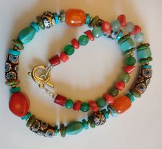 An eye catching Coral, Turquoise and mixture of African trade beads necklace.  Please note colours may appear different based on your monitor, lighting, etc. Sadly, some items are camera shy, making this task especially difficult. I do my best to represent the accurate colour. All items are carefully hand packaged in gift boxes to ensure they arrive in perfect condition. I will ship your order within 1 - 3 business days and all items are sent via the UK Royal Mail signed for service.  **If you w Gemstone Amulet Beads For Gifts, Artisan Long Turquoise Necklace Gift, Handmade Long Turquoise Necklace For Gift, Bohemian Polished Beads Necklace As Gift, Bohemian Polished Beads Necklace For Gift, Artisan Beaded Necklace With Gemstone Beads As Gift, Bohemian Spacer Beads For Gifts, Turquoise Polished Beads Necklace For Gift, Multicolor Natural Stones Necklace For Festivals