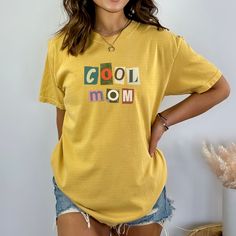 Comfort Colors Mustard Cool Mom Shirt Trendy Cotton Shirt With Letter Print, Yellow Printed Crew Neck Shirt, Casual Cotton Shirt With Letter Print, Yellow Cotton Tops With Graphic Print, Yellow Cotton Top With Graphic Print, Yellow Cotton Graphic Tee, Yellow Printed Cotton Shirt, Trendy Yellow Shirt With Screen Print, Yellow Cotton Top With Funny Print