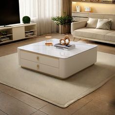 a living room with a couch, coffee table and television on top of a rug