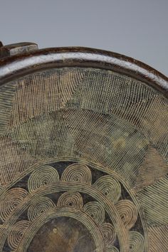 an old wooden table with intricate designs on the top and bottom edge, in front of a gray sky