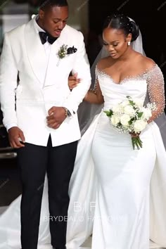 the bride and groom are walking down the aisle at their wedding ceremony in white tuxedos