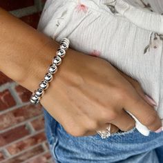 Every girl needs the classics... Our Classic Bead Bracelet comes to you in sterling silver with a magnetic closure and added secure safety chain. The generously sized beads measure approximately 9mm in diameter and create a look that is bold enough to wear alone or, if silver shine in layers is your style, can be stacked up with your favorites. The easy hidden closure contains a magnet that makes it a breeze to slip on or off. Available in 2 sizes:Standard (7.5 inches)Large (8.0 inches) for a sm Elegant Silver Stretch Bracelet With 8mm Beads, Adjustable Polished Beads Sterling Silver Bracelet, Trendy Silver Stretch Bracelet With Round Beads, Classic Adjustable Sterling Silver Bracelet With Polished Beads, Classic Sterling Silver Bracelet With Spacer Beads, Nickel-free Stretch Bracelet With Round Beads, Classic Adjustable Sterling Silver Stretch Bracelet, Elegant Silver Stretch Bracelet With Polished Beads, Classic Silver Beads Stretch Bracelet For Everyday