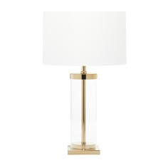 a gold lamp with a white shade on the base and a light bulb attached to it