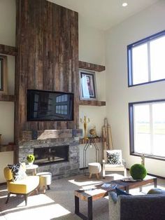 a living room with two couches and a television mounted on the wall above it