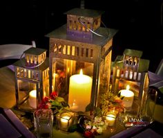 a table topped with candles and flowers on top of it