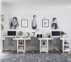 two computer desks with chairs and pictures on the wall