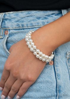 Held in place with white rhinestone encrusted silver fittings, pairs of pearly white beads are threaded along stretchy bands around the wrist.

 Sold as one individual bracelet. White Pearl Bracelet, White Bracelet, White Bracelets, Purple Rhinestone, Medallion Necklace, Paparazzi Accessories, White Rhinestone, Black Chain, Fabulous Jewelry