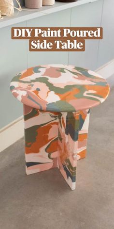 a pink and green chair sitting on top of a floor