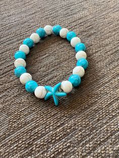 Color - Teal and Cream With Teal Starfish Charm Casual Star Jewelry For Summer, Casual Star-shaped Summer Jewelry, Casual Summer Star Shaped Jewelry, Turquoise Starfish Bracelet For Summer, Handmade Star Bracelets For Beach, Casual Beaded Bracelets With Starfish Charm, Casual Starfish Bracelet For Summer, Turquoise Starfish Bracelets For Beach Season, Turquoise Starfish Bracelet For Beach Season