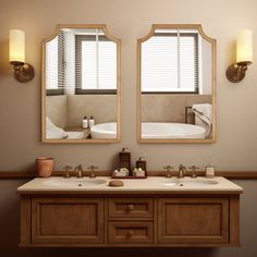 a bathroom with two sinks and mirrors on the wall next to each other in front of a bathtub