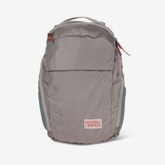 a grey backpack sitting on top of a white floor