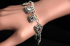 A collection of silver filigree-style heart charms have been dispersed around a shimmering silver plated bracelet chain in this handmade charm bracelet. This heart charm bracelet is then completed with a lobster clasp and a 1/2 inch of chain at the end for adjustable sizing. Charms in this bracelet include nine assorted heart charms in various decorative filigree designs. ● Sizing ● To determine your bracelet size, do a snug measurement of your wrist's circumference, then add 1/2 an inch. 6 to 6 Bracelet Fancy, Handmade Charm Bracelets, Hearts Bracelet, Filigree Heart, Bracelet Heart, Silver Plated Bracelet, Bracelet Chain, Filigree Design, Handmade Charms