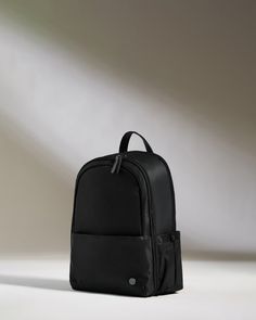 Our classic Chelsea Daypack has been reimagined with extra space. This smart, streamlined backpack has plenty of handy features: a back sleeve that slots over a suitcase handle, a full zip opener for easy packing and access, a zipped front pocket with card sleeve and key clip inside, a 16.5” laptop pocket, and an elasticated side pocket for a water bottle. The zipped, padded laptop pocket has an additional slip pocket for a tablet. Inside the backpack, there’s a removable packing pocket for shoe Nylon Standard Backpack For Business, Modern Commuting Backpack Luggage, Modern Standard Backpack Luggage For Commuting, Business Backpack With Anti-theft Pocket, Modern Commuting Luggage Backpack, Modern Travel Accessories Backpack With Zipper Pocket, Functional Standard Backpack Luggage For Business Trips, Functional Standard Backpack For Business Trips, Modern Black Backpack For Business Trips