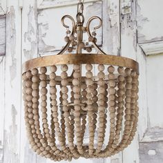 a wooden beaded chandelier hanging from the ceiling