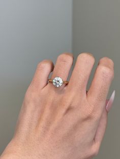 a woman's hand with a diamond ring on it