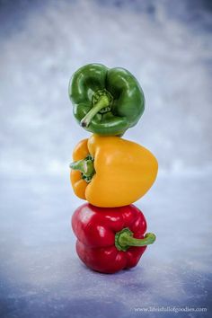 three peppers stacked on top of each other in the shape of a bell pepper and an eggplant