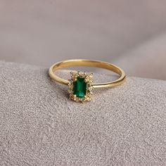 "Believed to be the \"stone of power\", emerald provides physical, spiritual and emotional balance. It is believed to increase spiritual growth, communication, joy, romance, harmony and unity. Our rectangular emerald stone ring surrounded by real diamonds will add elegance to your hands. It is a ring that you can use both on special occasions and in daily life. It is a beautiful and stylish product that you can gift to yourself and your loved ones. The color of those born in Emerald is May. Our Gold Emerald Cut Crystal Birthstone Ring, Gold Rectangular Emerald Ring For May Birthstone, Rectangular Gold Emerald Ring, Rectangular 14k Gold Emerald Ring As Gift, 14k Gold Rectangular Emerald Ring Gift, Emerald Ring With Rectangular Stone As Gift, Gold Emerald Ring With Rectangular Stone, Yellow Gold Emerald Ring With Rectangular Stone For Gift, Rectangular Emerald Gemstone Rings