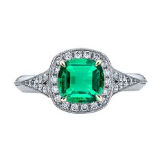 an emerald and diamond ring in white gold