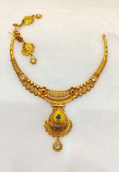 22k Gold Antique Necklace with Earrings set- Real Gold Necklace- Indian Gold Necklace- Solid Gold Necklace with little gemstones  This is beautifully handcrafted Indian Antique jewellery collection in 22k Gold Necklace with earrings set that gives you classy and Royal look  PRODUCT SPECIFICATIONS: Material: 22k Solid Gold Weight: 41 grams approx  Design: Antique theme  Customer satisfaction is our utmost priority fee free to have any query would love to assist you! We accept custom orders and custom designs as well! Jai Shree Shyam 🙏🙏 Happy Shopping 🛍️ Gold Dual-tone Jewelry Sets As Gift, Dual-tone Gold Jewelry Sets For Gifts, Dual-tone Gold Jewelry For Anniversary, 22k Gold Temple Jewelry Sets For Anniversary, Hand Set 22k Gold Jewelry Sets For Gift, Gold Necklace With Stone Setting For Anniversary, Gold Kundan Jewelry Sets With Gemstones, Gold Kundan Necklace With Stone Setting For Celebration, Gold Chandbali Jewelry With Stone Setting