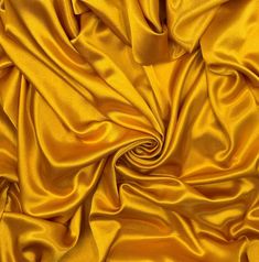 an image of a yellow cloth textured with silky folds and lines on the surface