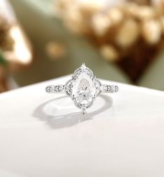 a diamond ring sitting on top of a table