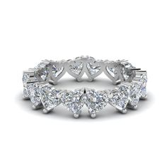 This prepossessing eternity band is a perfect gift idea for your loved one. Crafted in a gleaming metal, this diamond wedding band calls attention to its heart shaped diamond studded in classic prong setting.   Heart cut stones of 4 Total Carat Weight with Clarity VS2 and Color H in a prong setting. Total Number of Stones:- 16 This Heart Diamond Eternity Promise Ring is also available with a wide range of lustrous metals and gemstones of your choice. Free shipping within USA. One Year Luxury Heart-shaped Ring With Birthstone, Diamond Stackable Eternity Band For Promise, Diamond White Lab Grown Diamond Eternity Band For Anniversary, Diamond White Lab-grown Diamond Eternity Band For Anniversary, Diamond White Moissanite Eternity Band For Anniversary, Anniversary White Gold Moissanite Eternity Band, White Heart Cut Lab Grown Diamond Ring, Diamond White Stackable Diamond Eternity Band, Diamond White Diamond Eternity Band For Promise