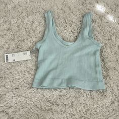 Never Worn, Perfect Condition. Light Blue Seamless Tank Top For Spring, Seamless Light Blue Crop Top For Spring, Light Blue Seamless Summer Top, Light Blue Ribbed Summer Top, Urban Outfitters Cotton V-neck Tank Top, Trendy Light Blue Top From Urban Outfitters, Blue Ribbed Cotton Crop Top, Trendy Light Blue Tops From Urban Outfitters, Basic Blue Tank Top For Summer