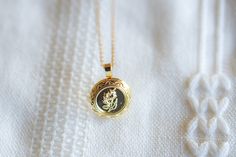 This locket necklace features a charming flower design and a flat circular shape. It serves as a keepsake for your most treasured memories, allowing you to insert a photo within it. Talk about a perfect gift idea! • How To Order1. Choose the size. 2. Select initials, if you do not want any initial, select "NONE"(UPPER CASE and HEART Shape Available) 3. Add to cart and submit order :) • Locket : Photo Frame Pendant, Flat Round with Flower, • Locket Size: about 0.79 inch x 0.89 inch • Initial Disk Vintage Charm Locket Necklace With Flower Pendant For Gift, Dainty Locket Necklace For Memorial, Dainty Locket Necklace For Memorials, Elegant Round Pendant Locket Necklace With Birth Flower, Elegant Round Locket Necklace With Birth Flower, Elegant Birth Flower Round Pendant Locket Necklace, Elegant Round Disc Necklace For Keepsake, Elegant Flower Charm Locket Pendant Necklace, Elegant Flower Charm Locket Necklace