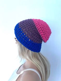 a woman with blonde hair wearing a crocheted hat on top of her head